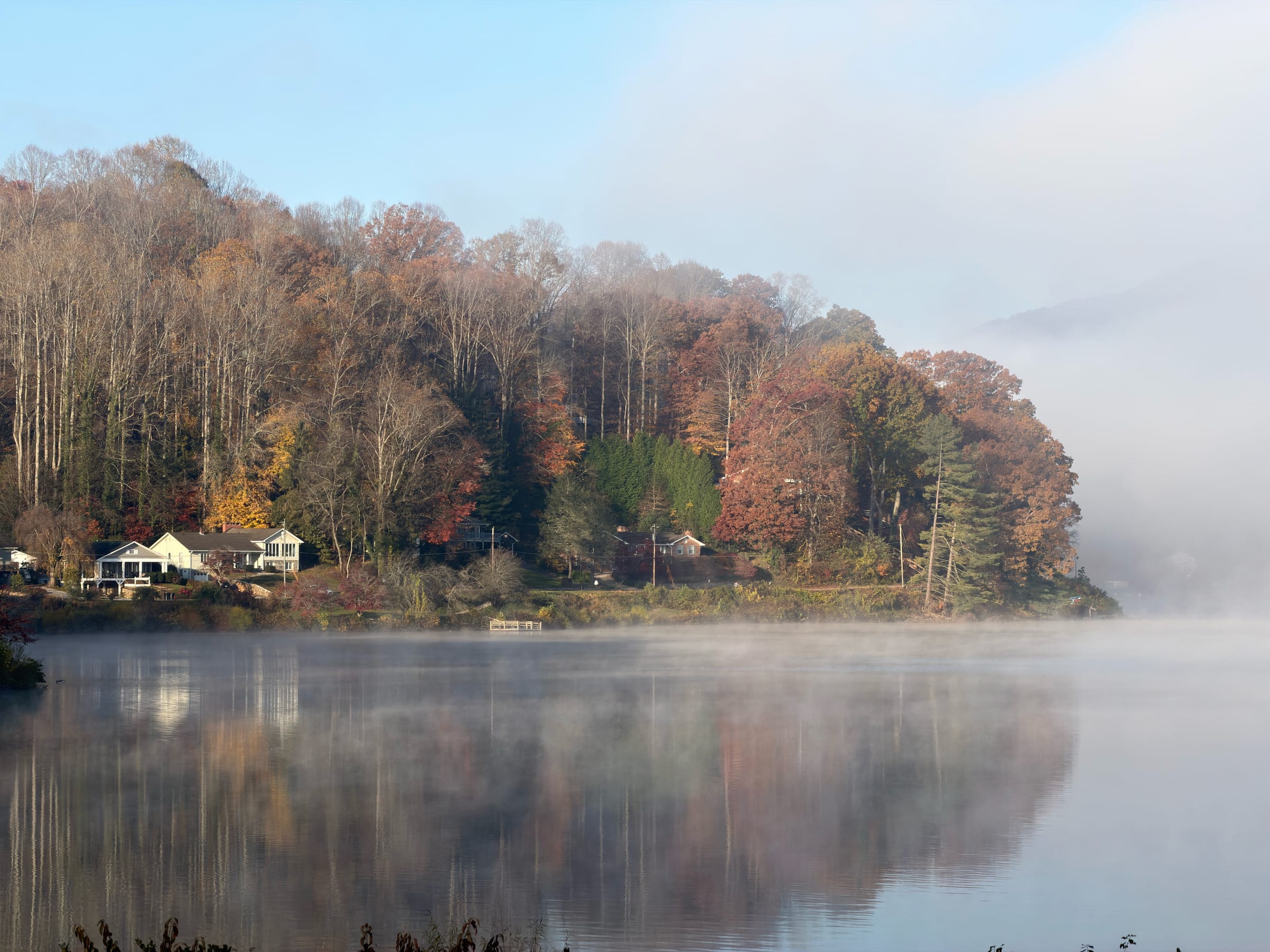Foggy autumn lake with fall colors