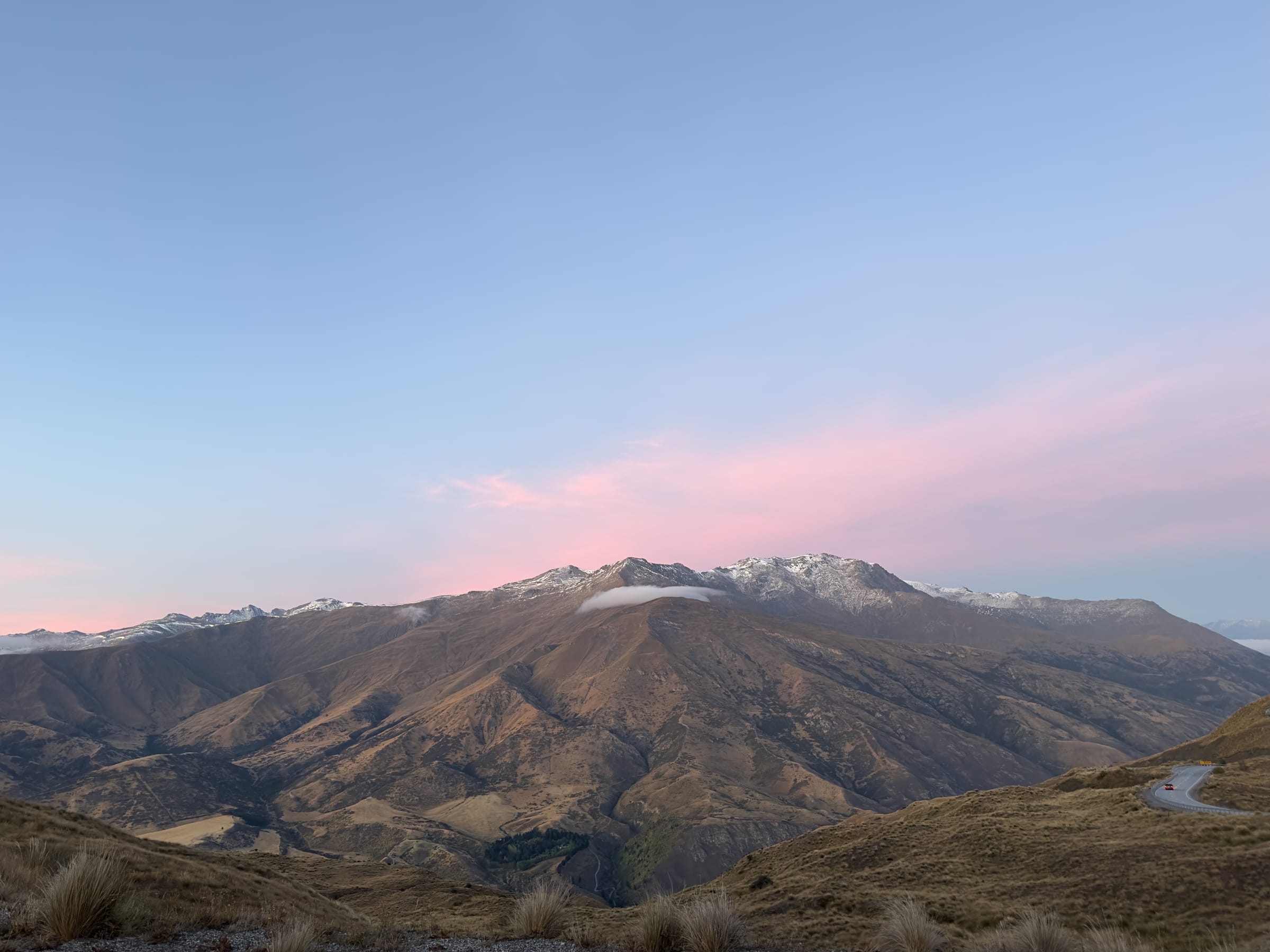 Snow-capped mountains at pink dusk
