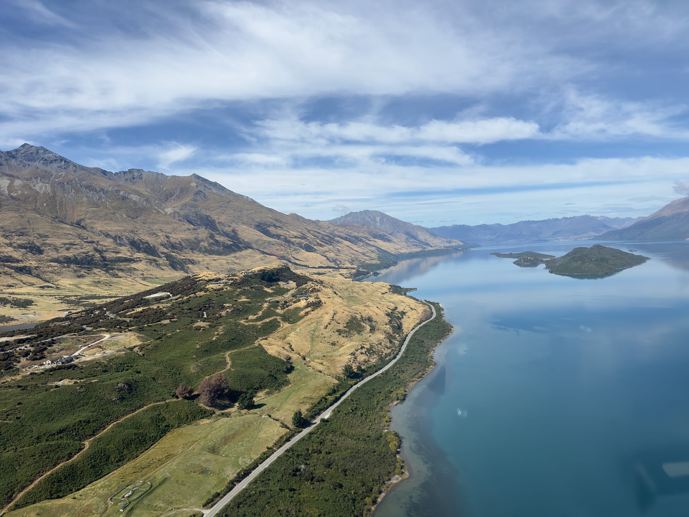 Aerial of mountains meeting calm lake