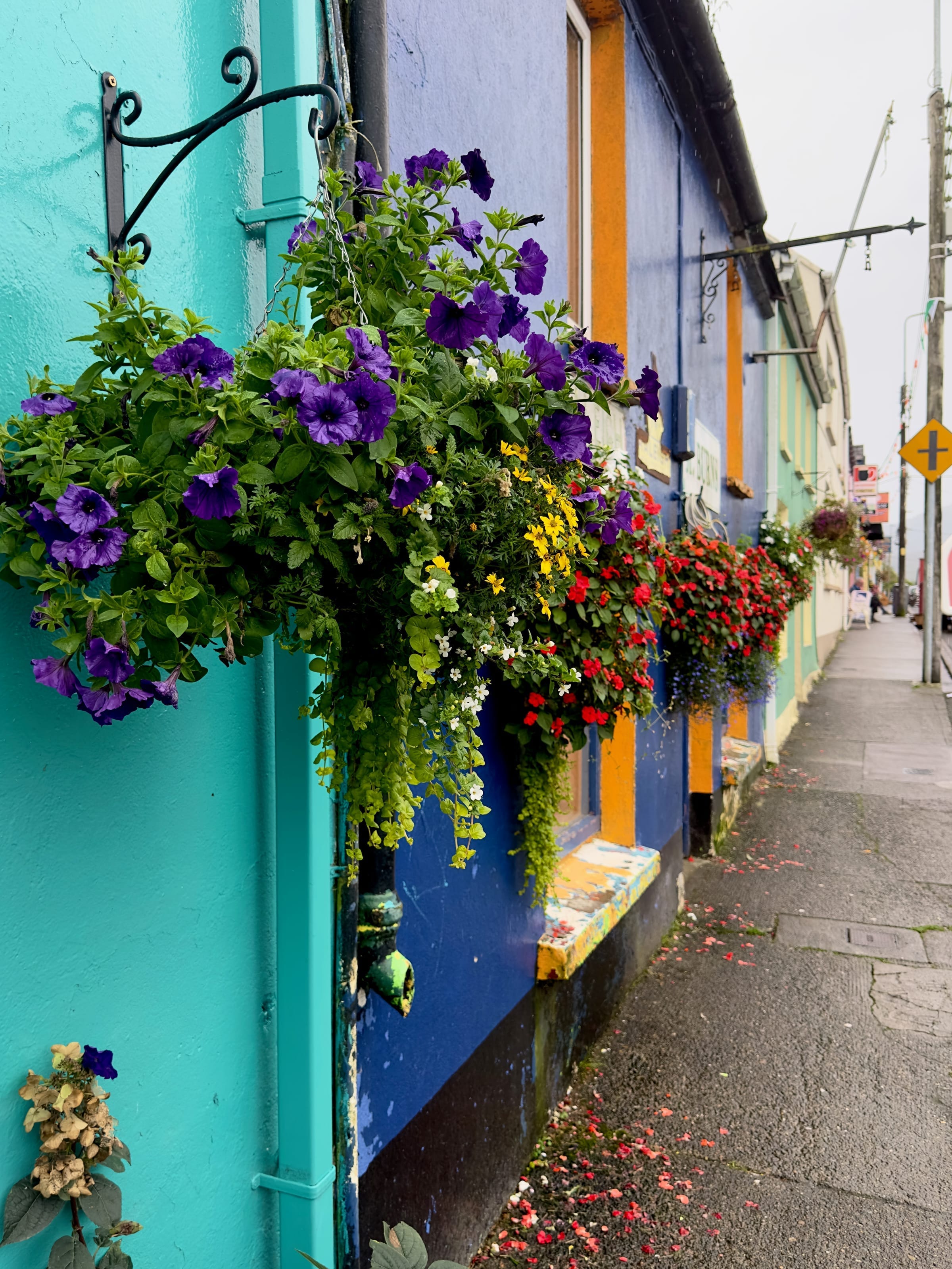 Colorful Irish street with hanging flower baskets