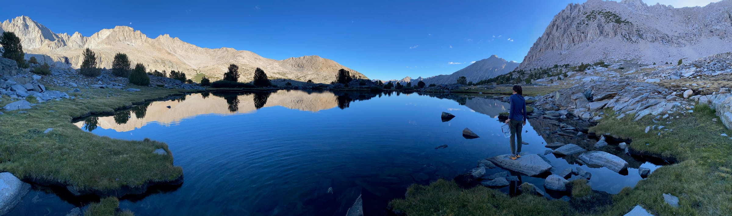 Alpine lake at dawn with mountain reflections