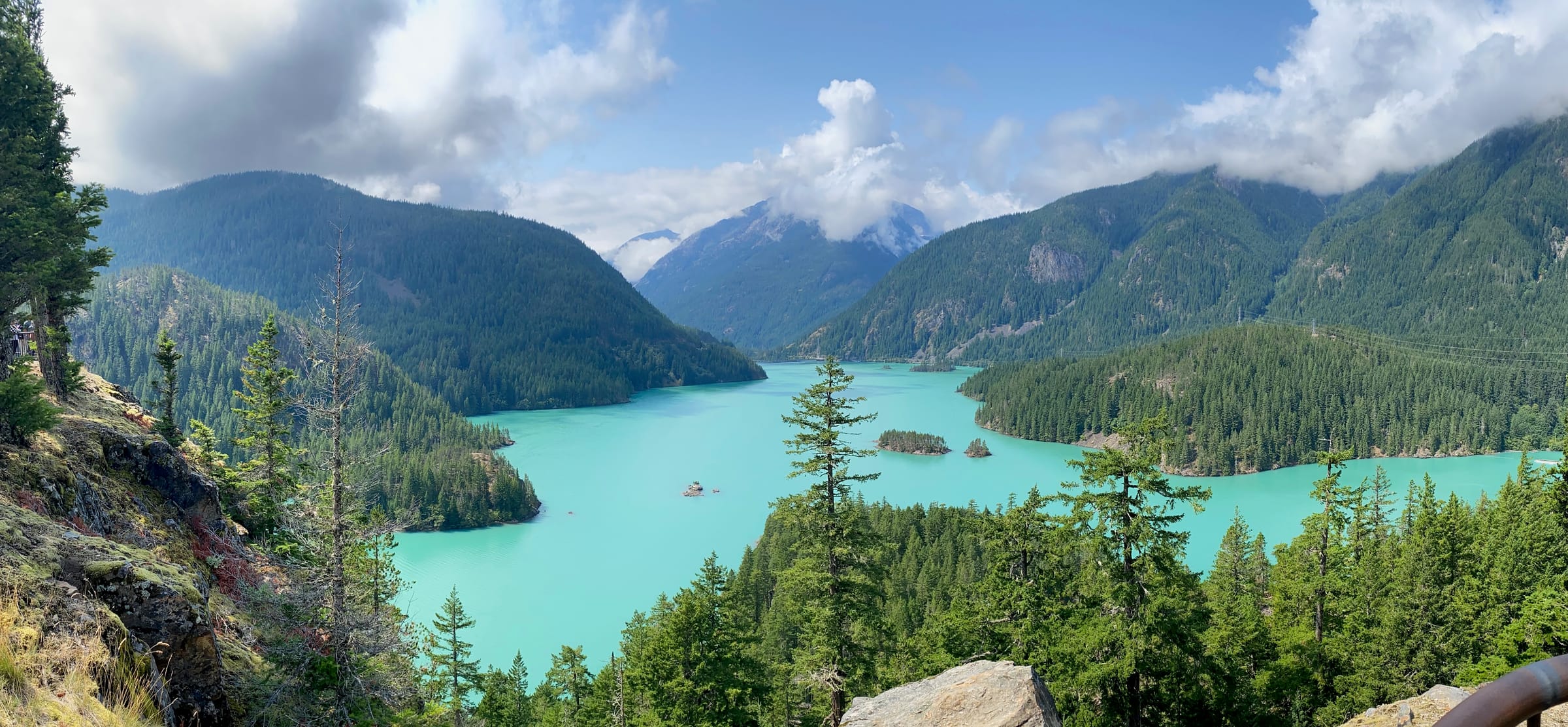 Panoramic view of turquoise Diablo Lake surrounded by mountains